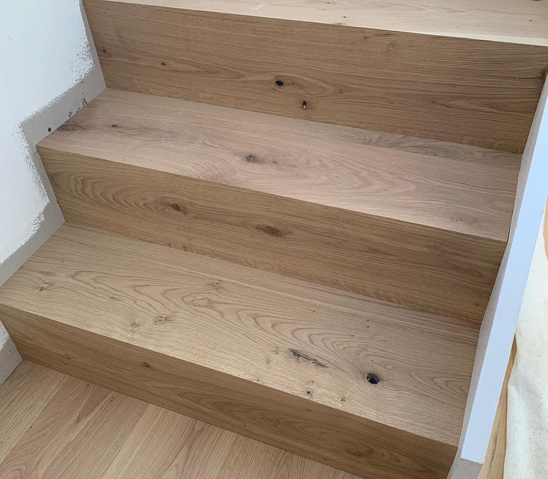 Close-up of natural oak grain and knots on finished stair treads